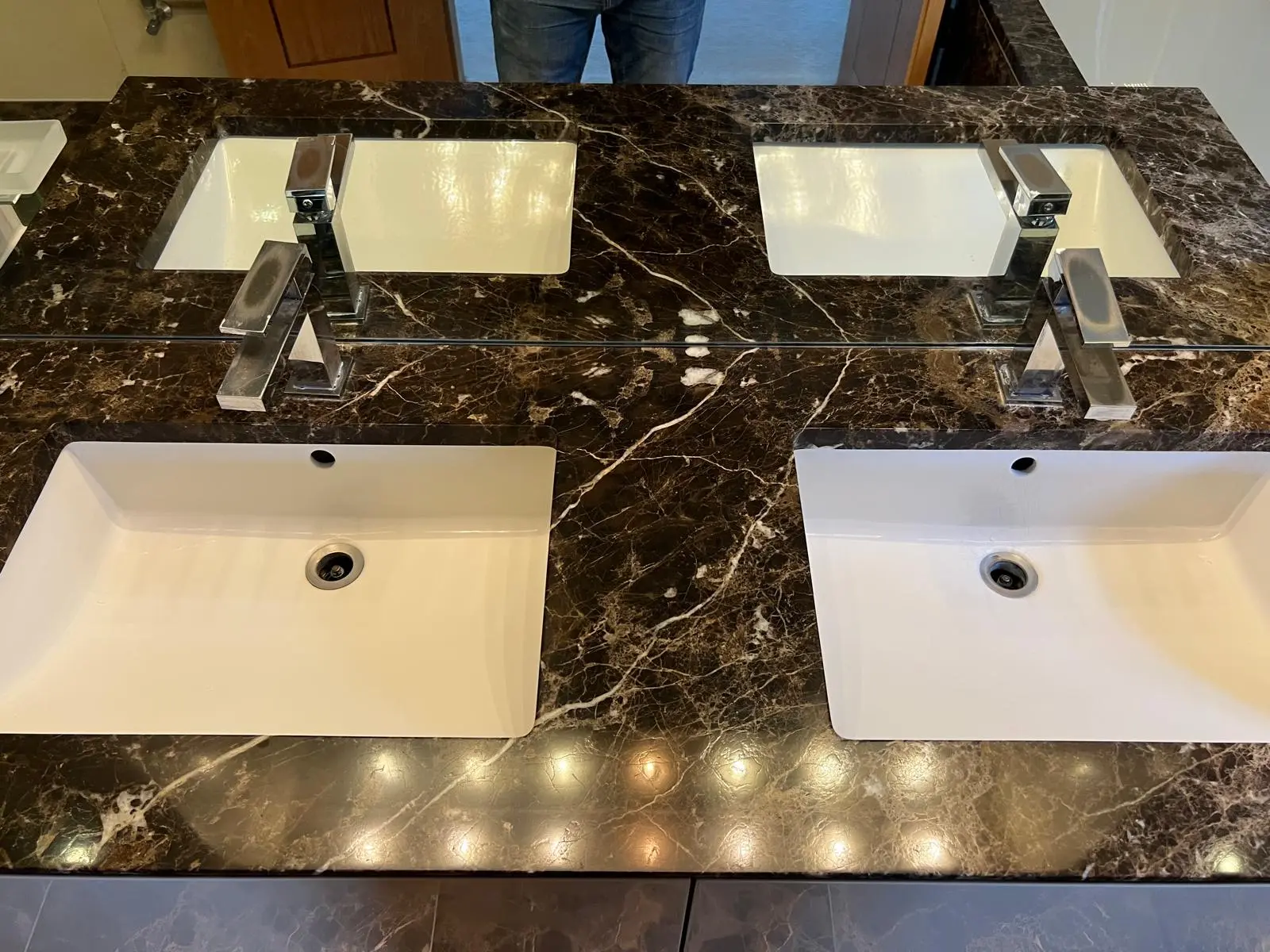 Marble bathroom vanity after restoration, polished and resealed twin-basin top with even sheen, London
