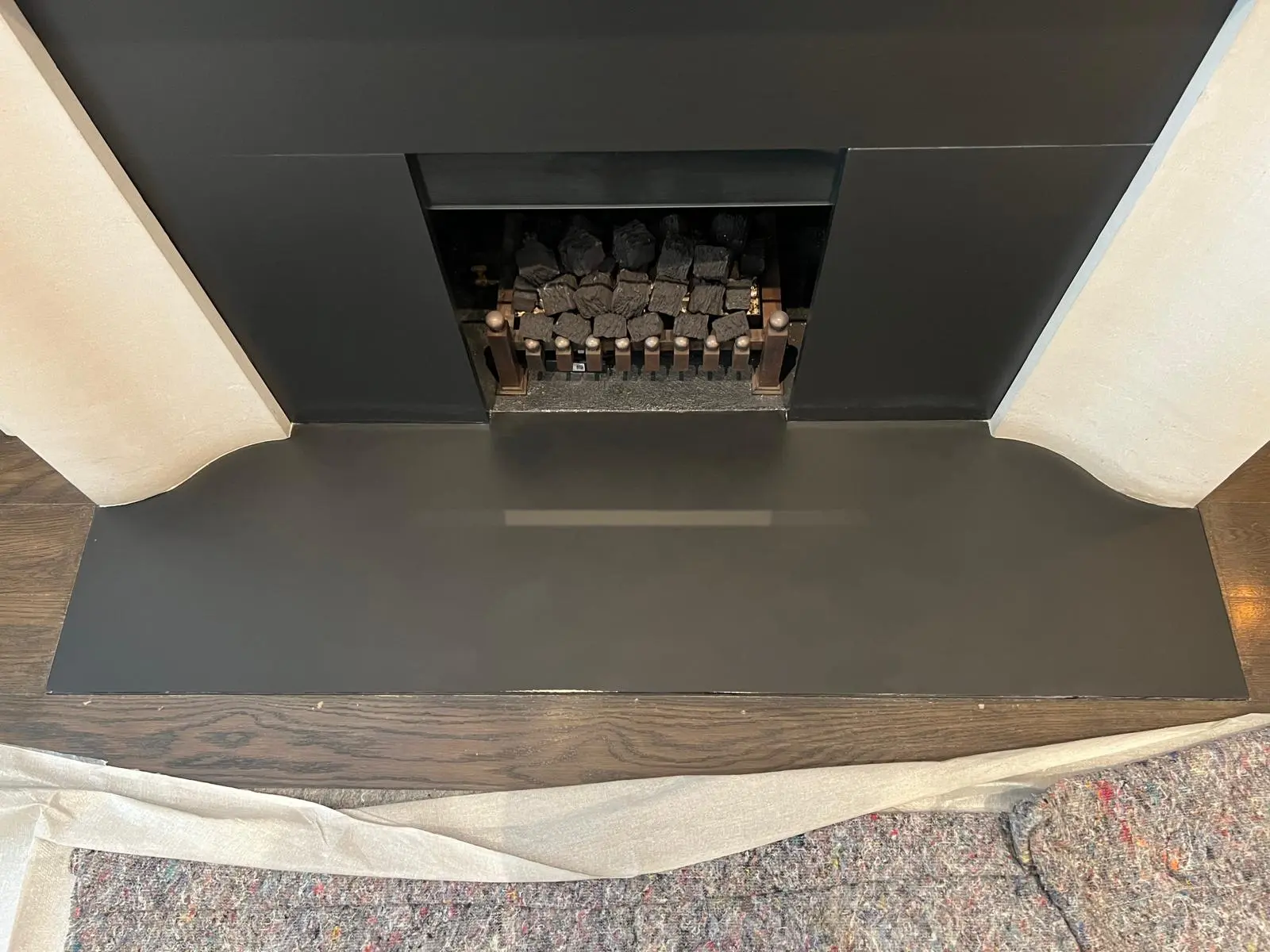 Stone fireplace and hearth after restoration, soot removed, hearth refinished and sealed, London period property