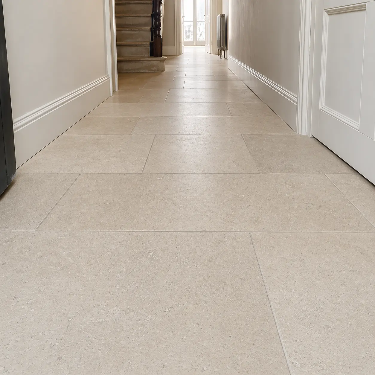 Limestone hallway floor restored to an even honed finish