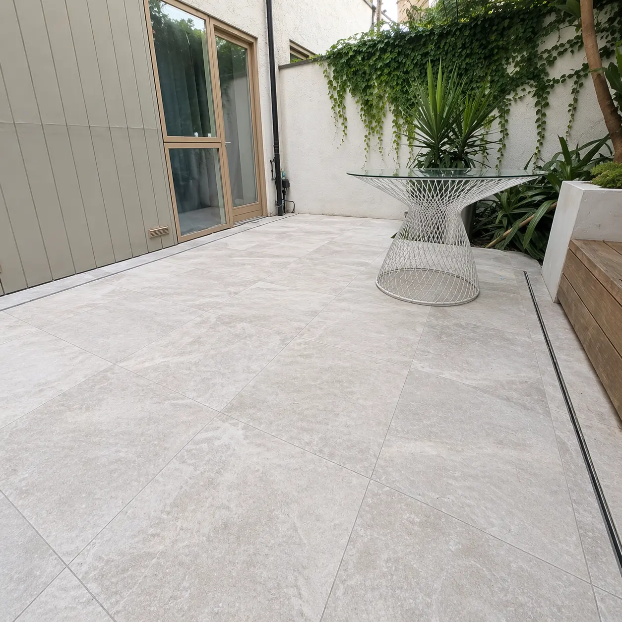Travertine patio paving after deep clean and void-fill, even colour and texture restored