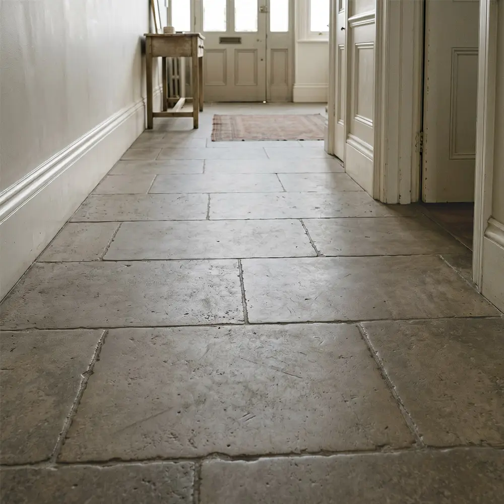 Same limestone hallway floor after impregnating sealer, richer tone and stain protection